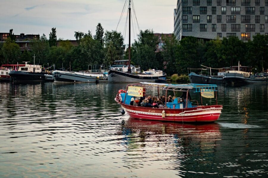 Amsterdam: Canal Cruise on a Wooden Refugee Boat - Practical tips for the open-boat ride in Amsterdam