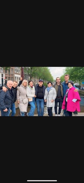 Amsterdam: Day City tour with local Guide in German - Chinatown Photo Stop: A Quick Change of Mood
