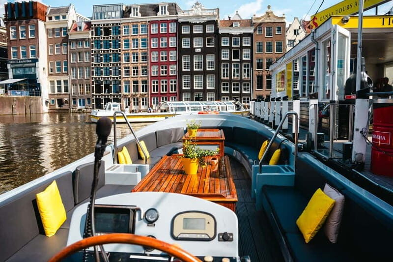 Amsterdam: Open Boat Tour of Canals with Expert Local Guide - Catching landmark views: Rijksmuseum area and Magere Brug