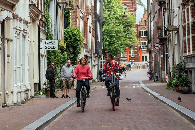 Amsterdam PRIVATE Bike Tour With Locals: Bike & Local Snack Included - Homomonument: a respectful pass-by with local context