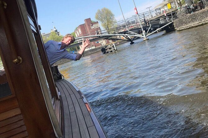 Amsterdam small-group canal cruise in 1920s saloon boat - Comfort on board: covered seating, heater, and blankets for Dutch weather