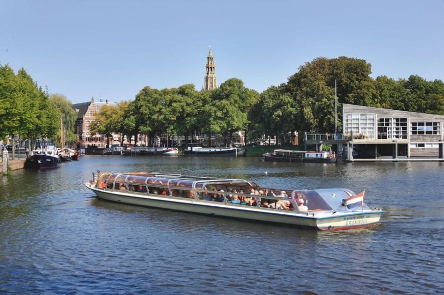 Groningen: City Canal Cruise - Floating Past the Martinitoren: The Iconic Tower Moment