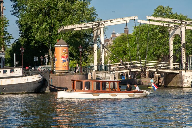 Private Boat Tour Amsterdam - 90 Min incl. welcome drink on historic saloon boat - How the English Guide Makes the Tour Fit Your Interests